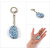Small painted pebble keychain with metallic blue and white doodles