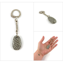 Small painted pebble keychain with black and white doodles