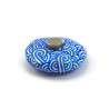 White painted round false pebble with metallic blue doodles magnet