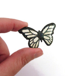 Magnet féérique en forme de papillon transparent et noir à paillettes