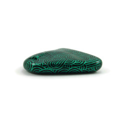 Painted pebble with metallic green doodles on black background