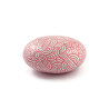 Painted pebble with candy pink doodles on white background