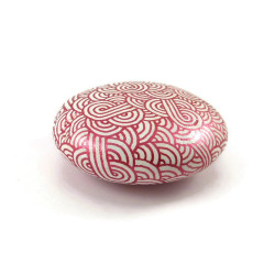 Painted pebble with metallic fushia pink doodles on white background