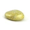 Painted pebble with golden doodles on white background