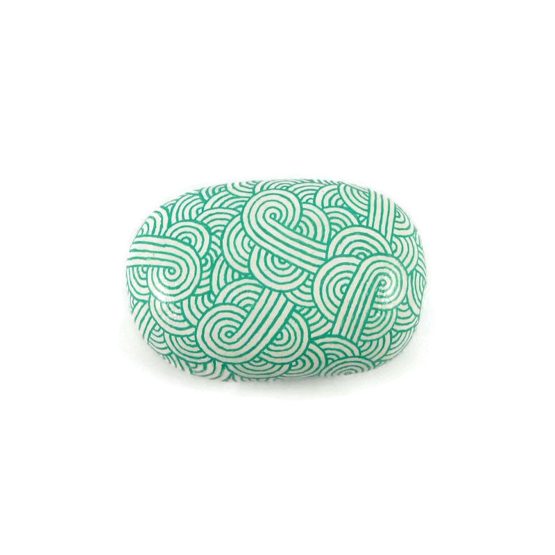 Painted pebble with green mint doodles on white background