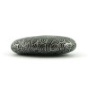Painted pebble with silver doodles on black background