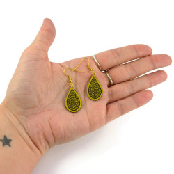 Golden droplets dangle earrings with black doodles