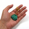 Painted rock keychain with metallic emerald green and black doodles