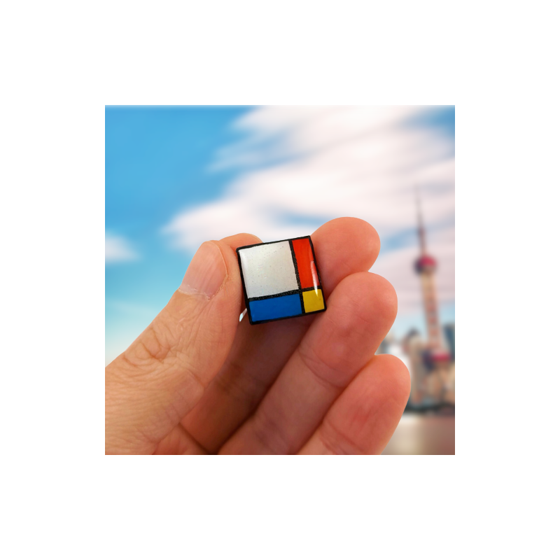 Square pin badge in the style of Mondrian