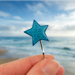 Eco-friendly hair pin in the form of teal blue star with aqua blue doodles