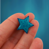 Eco-friendly pin badge in the form of teal blue star with aqua blue doodles