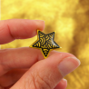 Eco-friendly pin badge in the form of gold star with black doodles