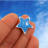 Eco-friendly magnet in the form of white star with metallic blue doodles
