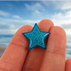 Eco-friendly magnet in the form of teal blue star with aqua blue doodles