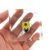 Fake yellow and black bug included in a clear epoxy resin block
