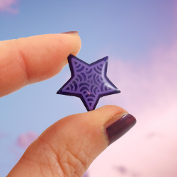 Purple star pin badge with lilac doodles