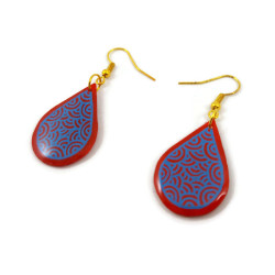 Red teardrops dangle earrings with blue doodles