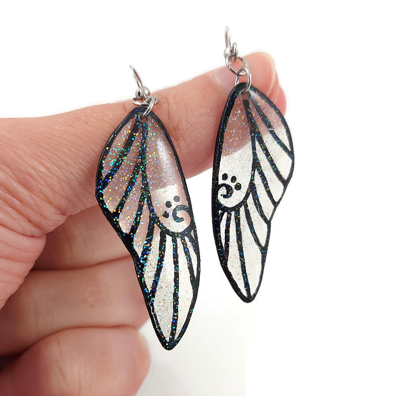 Boucles d'oreilles ailes de fée transparentes et noires pailletées