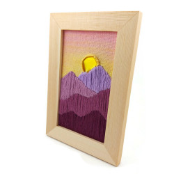 Embroidery of a sunset over mountains