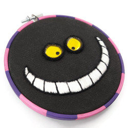Cheshire Cat embroidery, with a phosphorescent smile