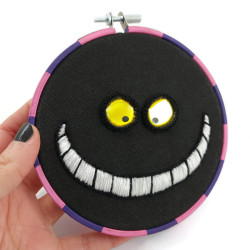 Cheshire Cat embroidery, with a phosphorescent smile