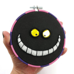 Cheshire Cat embroidery, with a phosphorescent smile
